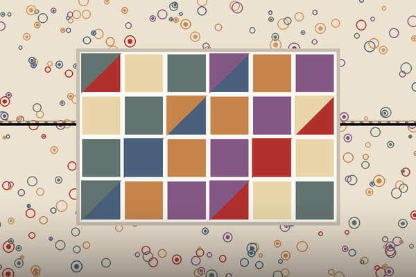A patchwork quilt top laid on a larger printed backing, with the backing seam running across behind it