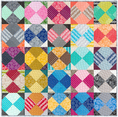Scrappy quilt of twenty five blocks, each a four patch octagon in two bright prints framed by four dark corner triangles