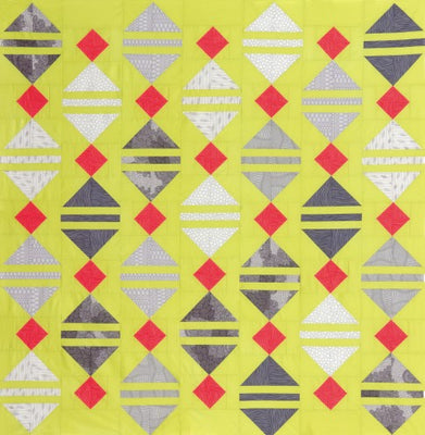 Limeade quilt with grey lantern shapes and red accents on a lime green background