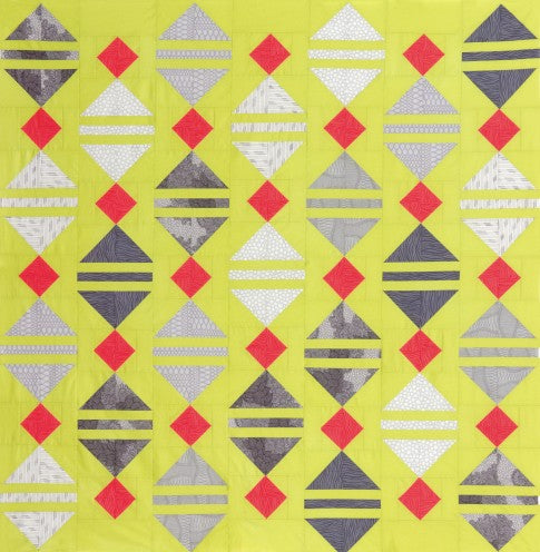 Limeade quilt with grey lantern shapes and red accents on a lime green background
