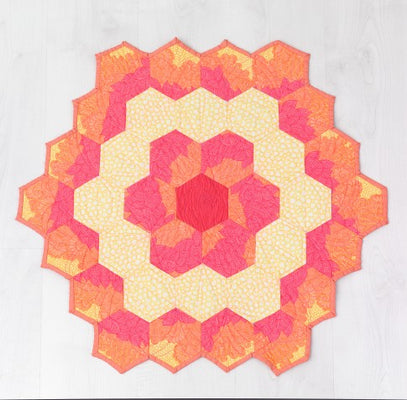 Peony mini quilt made from rings of hexagons blooming from rose to soft yellow