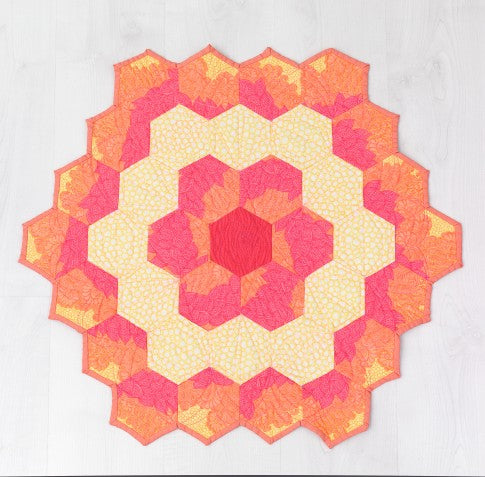 Peony mini quilt made from rings of hexagons blooming from rose to soft yellow