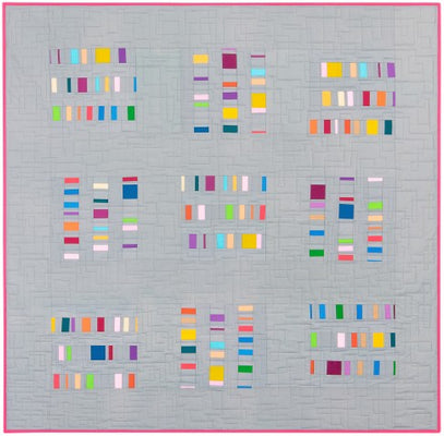 Frameworks quilt with nine grey frames of small colourful strips on a grey background with a pink border