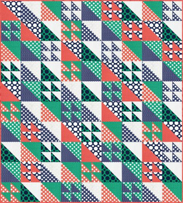 A playful spotted baby quilt made from a mix of leftover fabric pieces