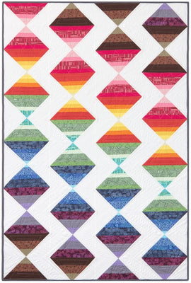 A modern strip quilt with colours flowing like the seasons, finished at 48 by 72 inches
