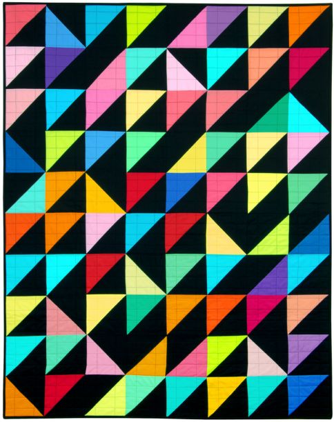 A bright half square triangle quilt made in solid colours