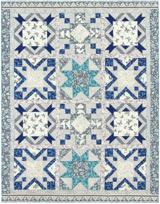 Stars Aflutter quilt, a sampler of blue and teal star blocks with soft floral centres on a grey background