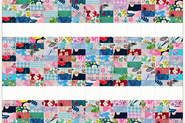 Aspen quilt in Blossom Breeze prints, wide bands of pink and aqua strips separated by bands of white squares across the quilt