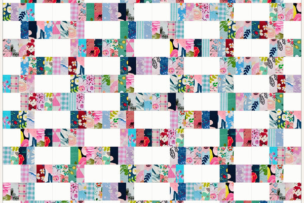 Blackthorn quilt in Blossom Breeze prints, white blocks and bands of pink, aqua and navy print staggered like brickwork across nineteen rows