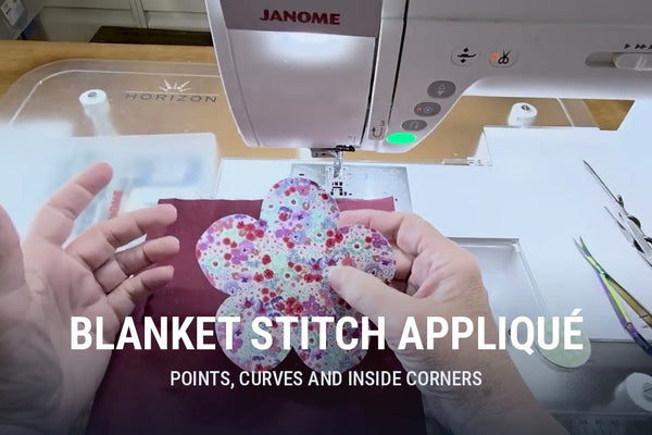 Yvonne holding a fused fabric flower appliqué at the sewing machine, ready to blanket stitch around the edge