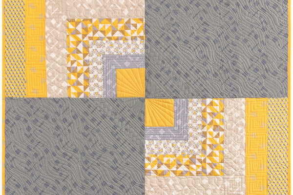 Broken Perimeters quilt, two half log cabin blocks in yellow and gray set diagonally against two plain gray squares