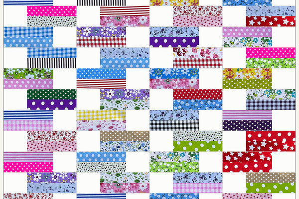 Cherry Blossom quilt in Patchwork Carnival prints, sixty blocks of two bright strips and a white square staggering from row to row