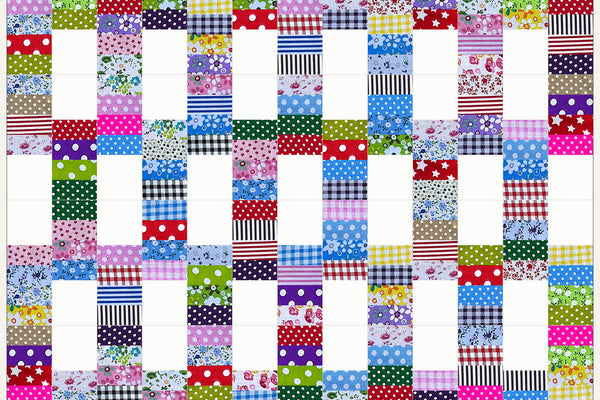 Dogwood quilt in Patchwork Carnival prints, white squares meeting in pairs to form windows inside a lattice of checks, stripes and dots