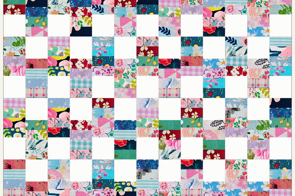 Hawthorn quilt in Blossom Breeze prints, columns of four pink, aqua and navy strips alternating with white squares down the length of the quilt