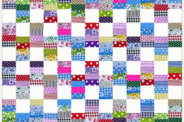 Hawthorn quilt in Patchwork Carnival prints, columns of checks, stripes and polka dots alternating with white squares down the length of the quilt