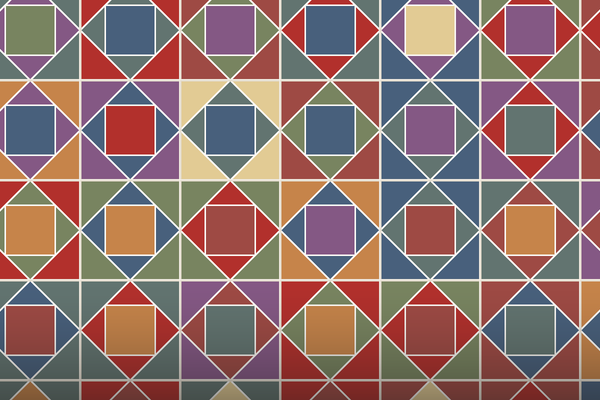A field of square in a square quilt blocks in red, blue, plum, green, ochre and cream