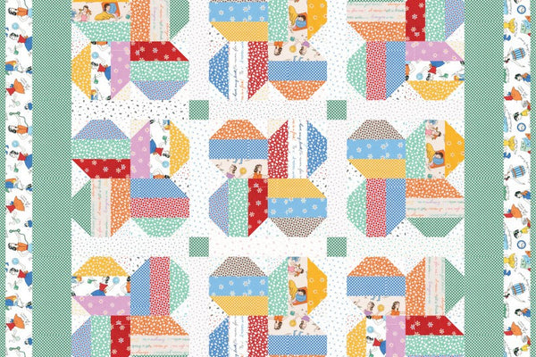 Lady Luck quilt, sixty strip pieced blocks with snowballed corners grouped in fours on a white background, with green sashing cornerstones and a novelty print outer border
