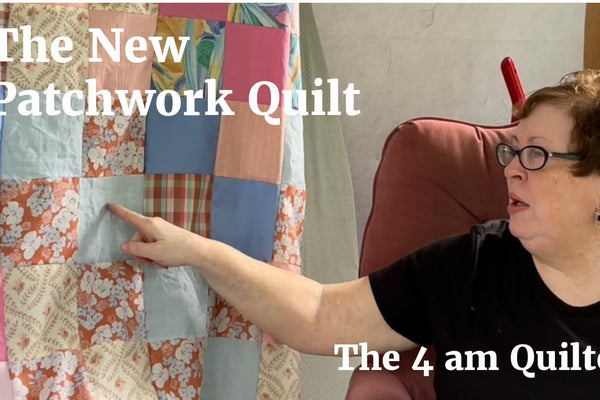 A new patchwork quilt top beside an older patchwork quilt