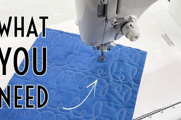Quilt layers rolled onto lengths of timber and unrolled a band at a time across a table for basting