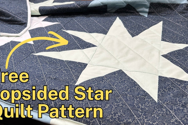 a lopsided star quilt block with flying geese on two corners and elongated half rectangle triangle points on the other two, solid stars on a printed background