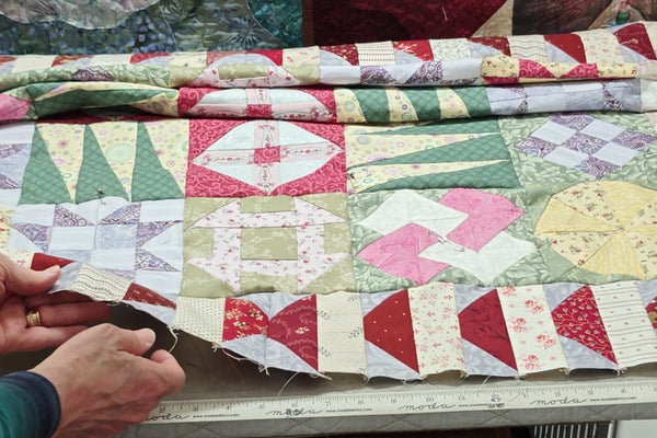 Evaluating a quilt top for square, wavy borders and bias stretch before quilting