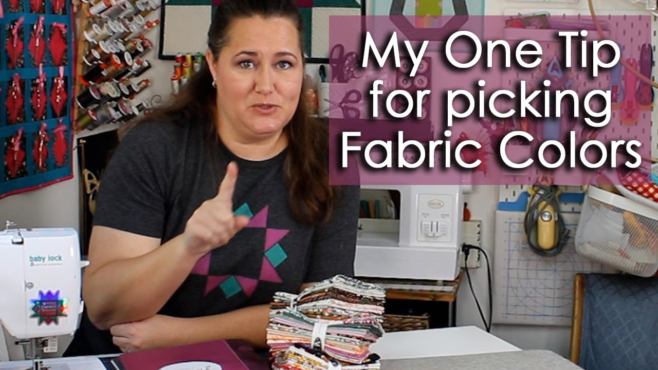 A group of quilting fabrics laid out together and tested for shared colours and tones before cutting