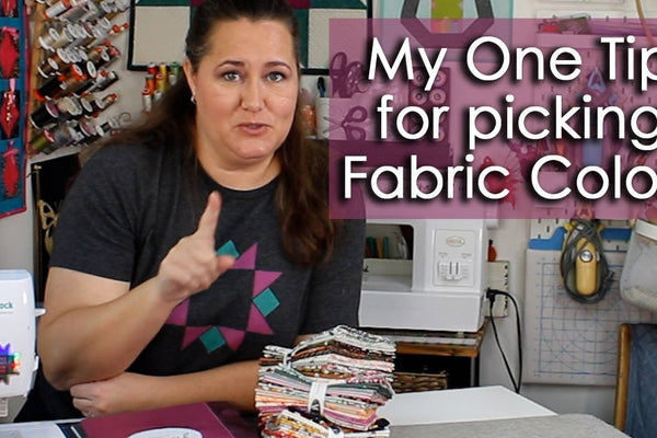 A group of quilting fabrics laid out together and tested for shared colours and tones before cutting