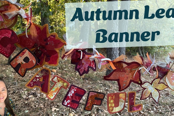 a fall banner of scrappy fabric leaves on wool felt strung on ribbon
