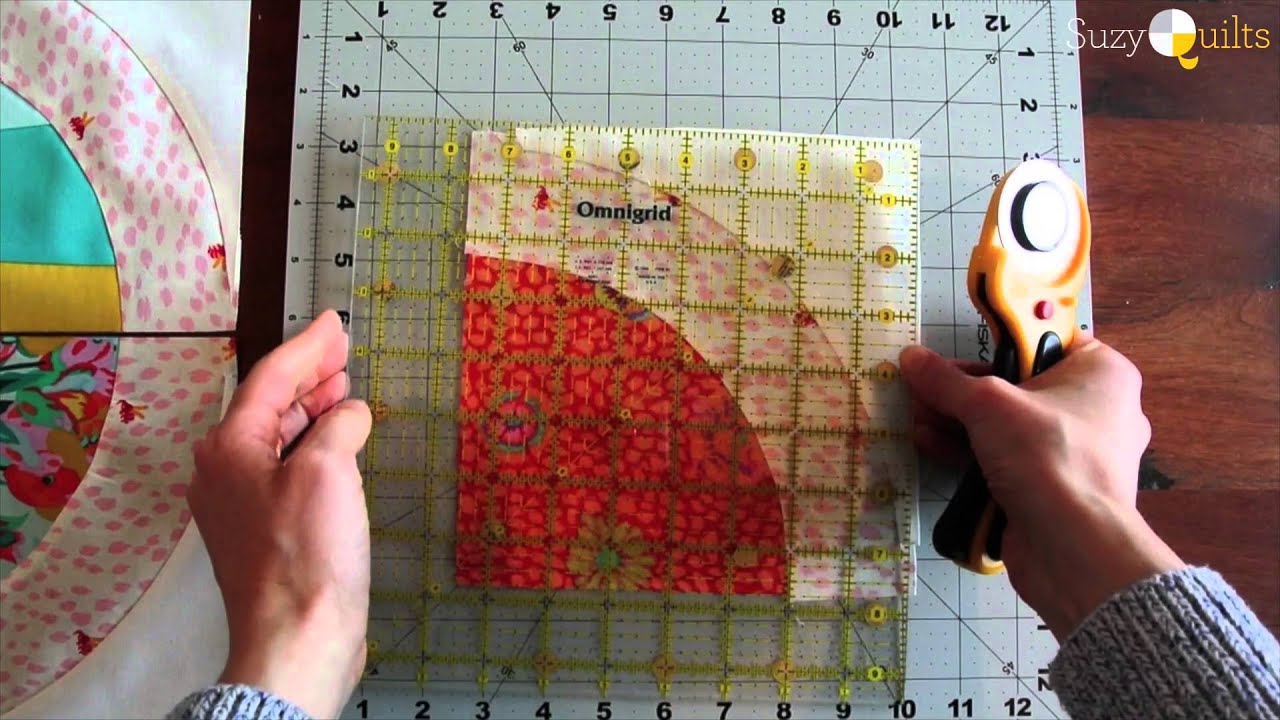 A curved seam being sewn at the machine with the fabric adjusted a stretch at a time and no pins