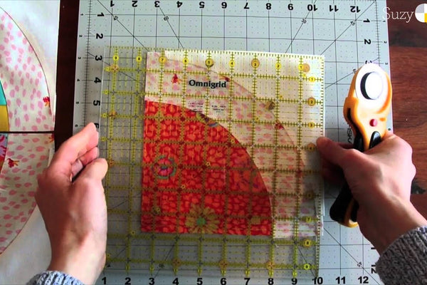 A curved seam being sewn at the machine with the fabric adjusted a stretch at a time and no pins