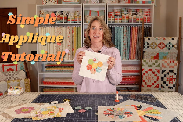 a Grandmother's Flower Garden hexagon flower being hand appliqued onto a plain background fabric