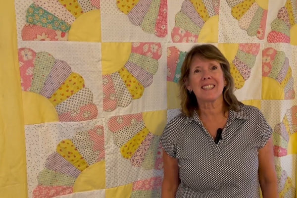 thirty hand pieced fan blocks appliqued onto white squares and set five across and six down into a quilt top
