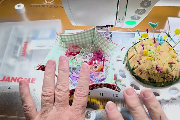 Essential quilting tools beside a sewing machine