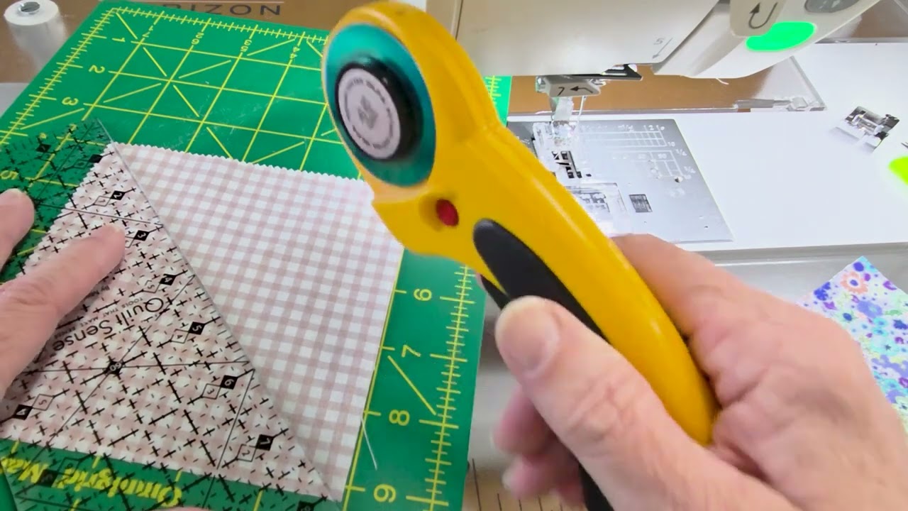 Yvonne at the sewing machine, changing the presser foot partway through a flying geese demonstration