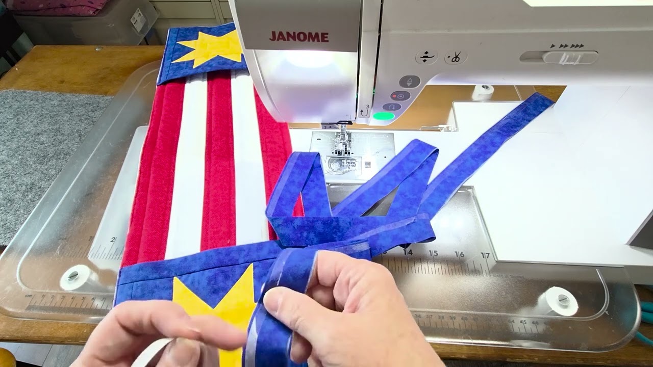 Yvonne of The Fabric Hut machine sewing quilt binding with fusible web tape along the folded edge