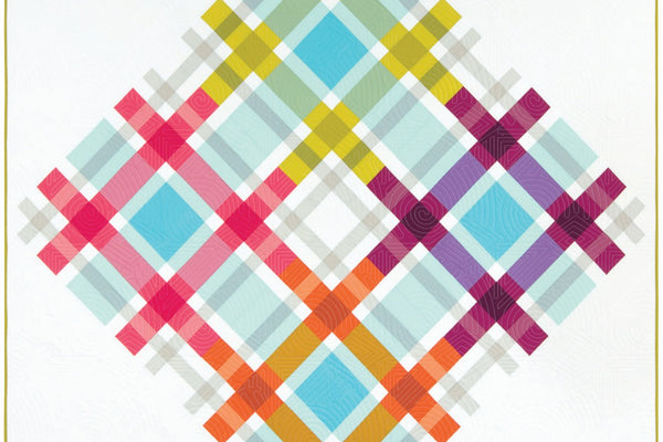 Plaid on Point quilt, a large multicolored plaid turned on point and floating on a white background, worked in bright Kona cotton solids