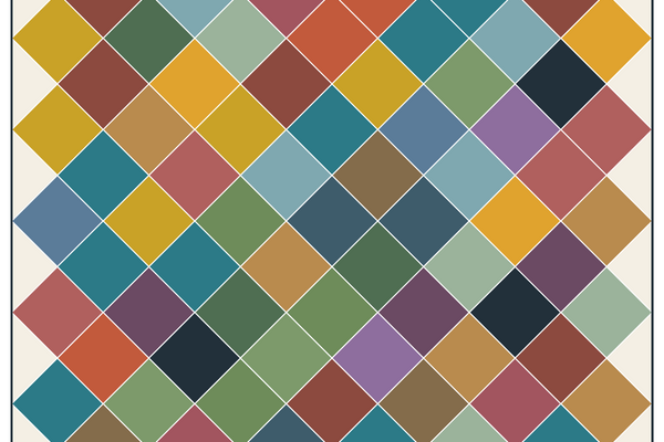 Scrap quilt of 5 inch squares in many different prints, set on point on a cream background