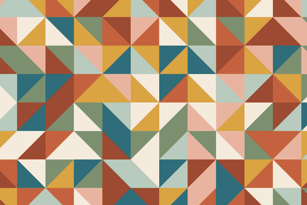 Quilt top of half square triangles in terracotta, mustard, sage, teal and cream