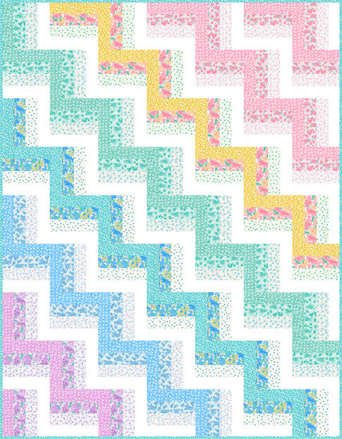 Railings rail fence quilt in soft teal, pink, yellow and blue prints with white strips, the blocks turned to form a zigzag