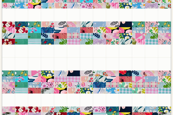 Rowan quilt in Blossom Breeze prints, three rows above and three below mirrored so the white squares open into a wide band across the middle