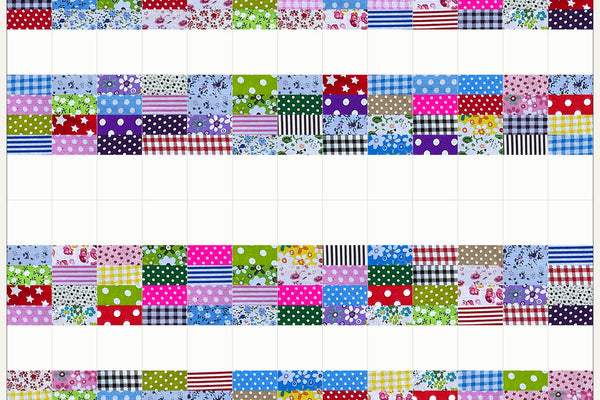 Rowan quilt in Patchwork Carnival prints, three rows above and three below mirrored so the white squares open into a wide band across the middle
