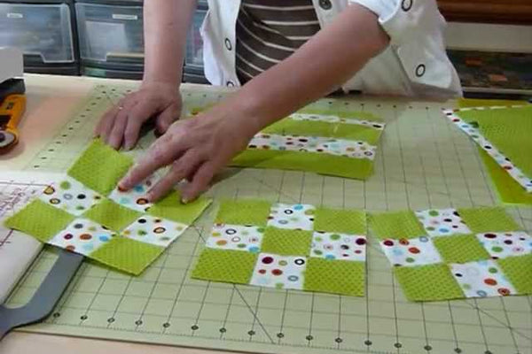 Nine patch blocks in a light and a dark fabric, built from strip sets cut from two fat quarters