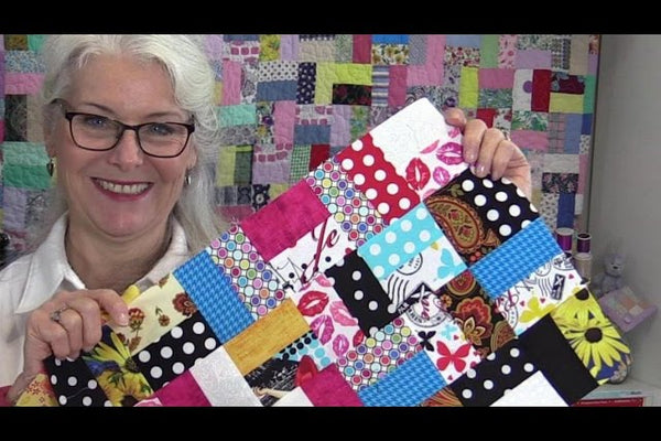A true scrappy quilt made from unsorted pieces all cut to the same size, with no matching fabrics