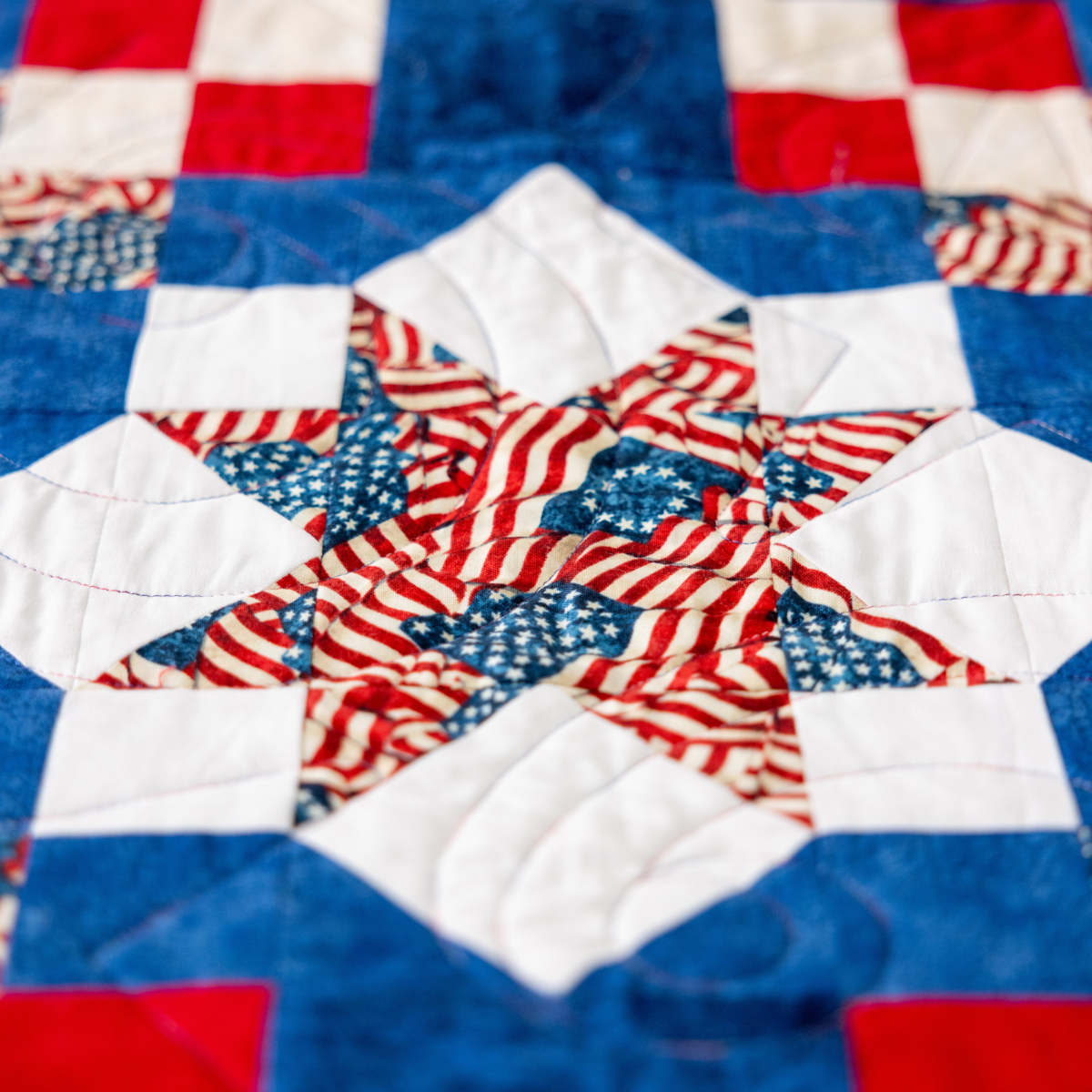Close up of the Sawtooth Star block in Because of the Brave, Northcott America 250 Stonehenge fabric