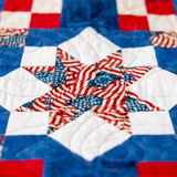 Close up of the Sawtooth Star block in Because of the Brave, Northcott America 250 Stonehenge fabric