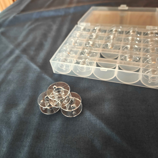 25 Clear Bobbins with Storage Box - Universal Class 15 Size A