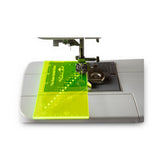 The Fabric Hut Seam Guide Ruler in fluorescent yellow-green acrylic with 16 needle holes, shown with the free magnetic seam guide (view 2)