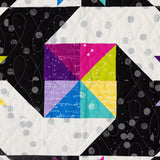 Close up of the star block in Stars at Sea, half square triangles in bright FIGO fabrics