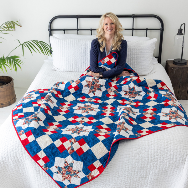 Because of the Brave patriotic quilt styled on a bed, America 250 quilting kit