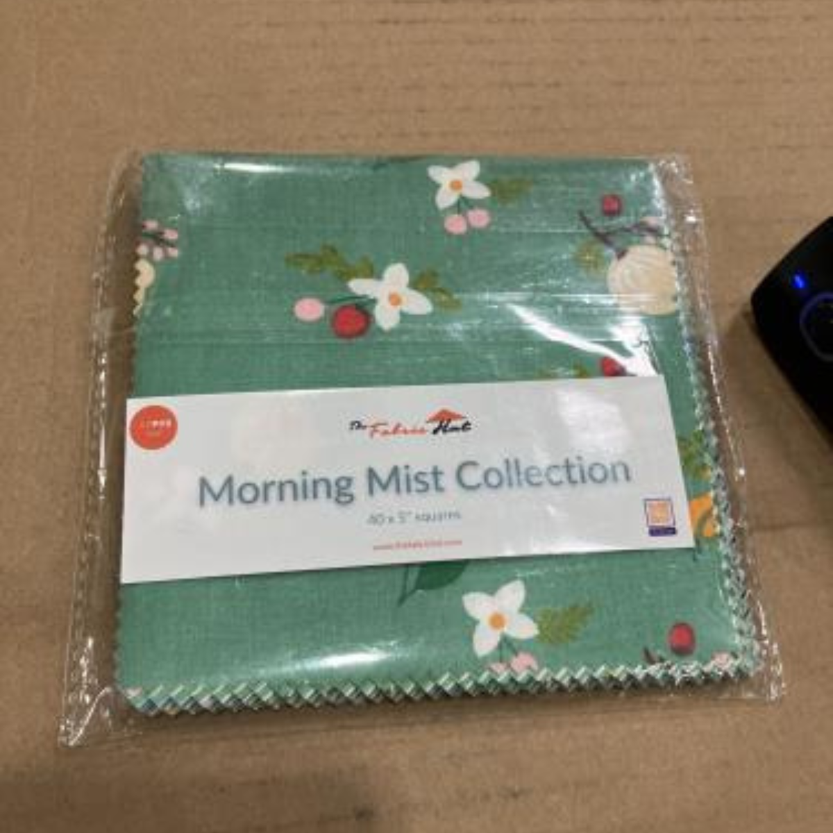 Morning Mist 5 inch charm squares laid out, part of the 480 piece four collection sampler bundle